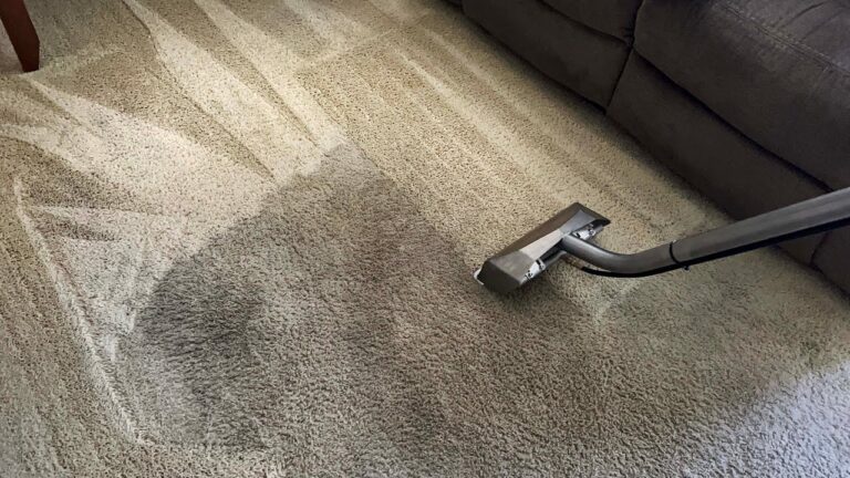 A close-up of a dirty carpet texture showing trapped dust and allergens in a Dubai home